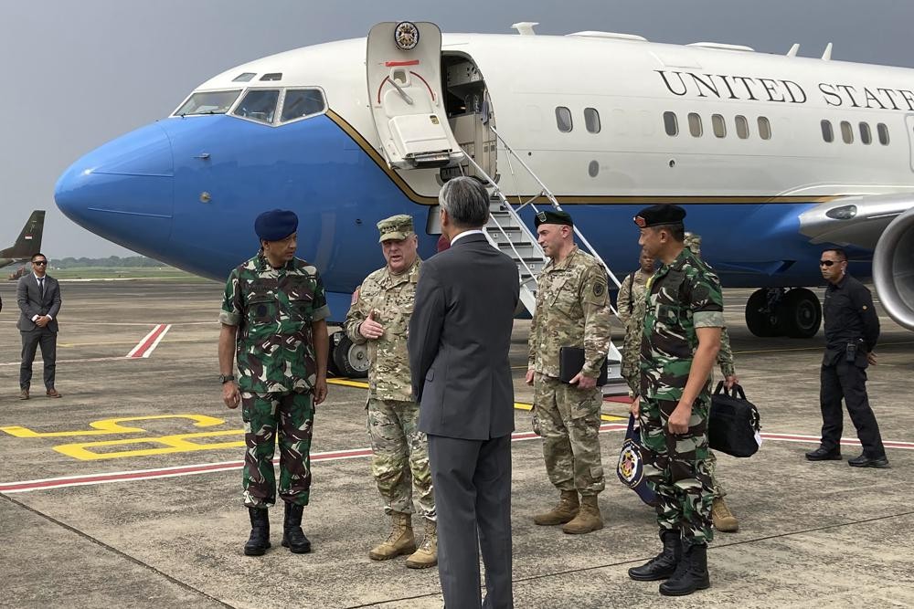 U.S. Army Gen. Mark Milley, center left, chairman of the US Joint Chiefs of Staff, arrives in Jakarta on Sunday, July 24, 2022, for meetings with defense leaders. The Chinese military has become significantly more aggressive and dangerous over the past five years, the top U.S. military officer said during a trip to the Indo-Pacific that included a stop Sunday in Indonesia. (AP Photo/Lolita C. Baldor)